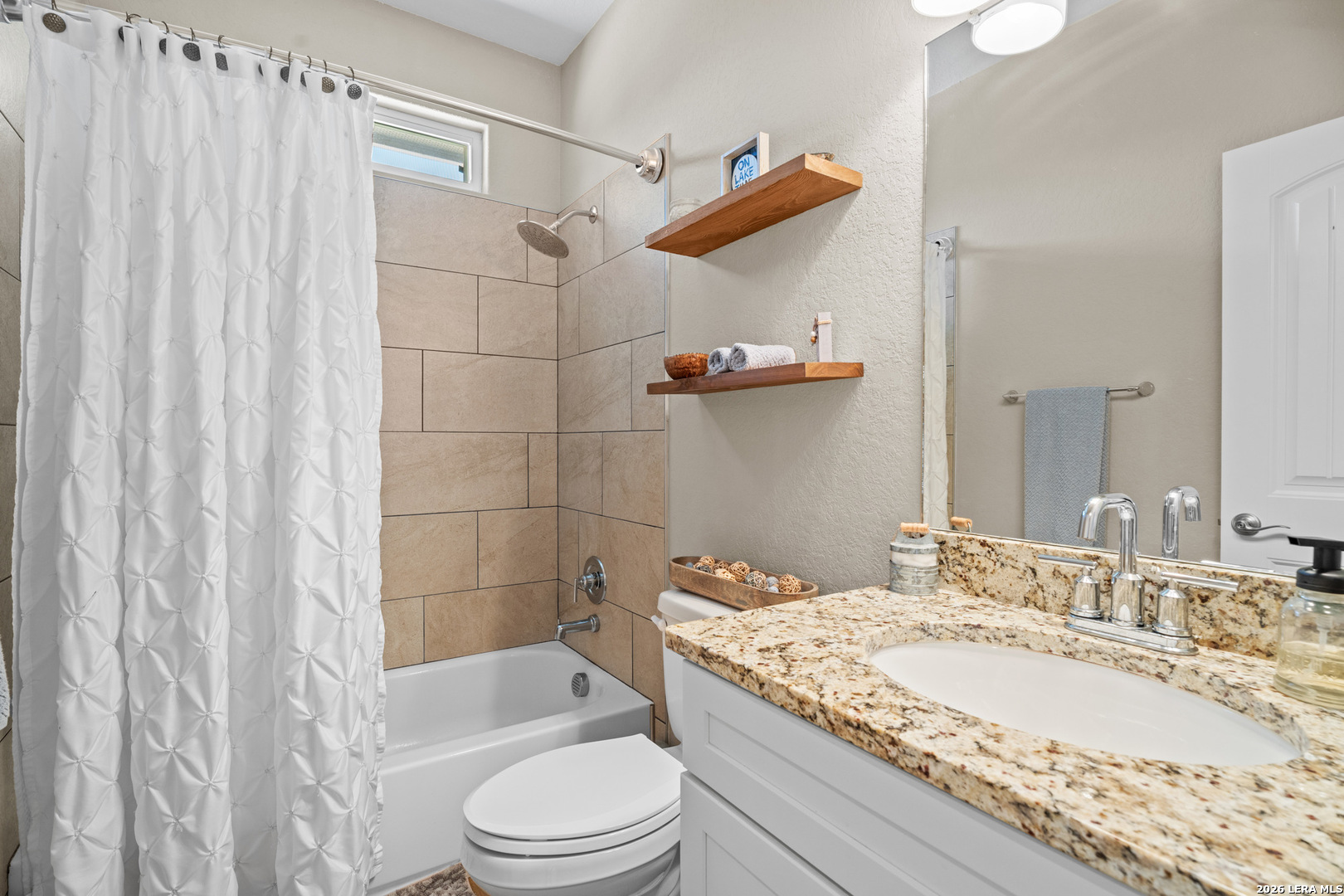 819 Primrose Path Spring Branch, TX 78070 - Photo 12 of 17 a bathroom with a granite countertop sink toilet and shower