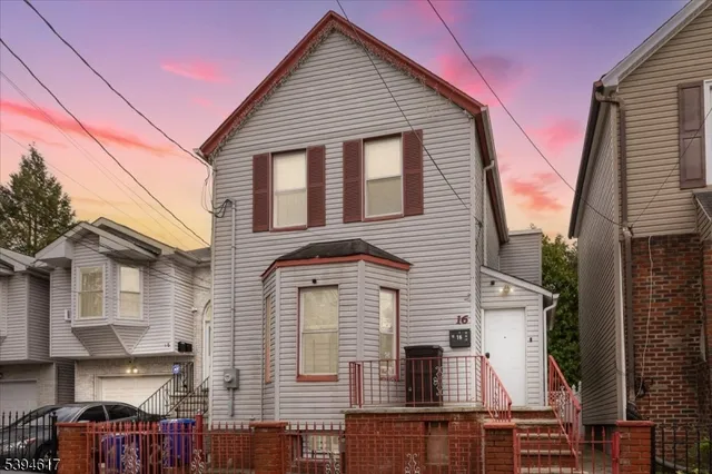 a view of a house with wooden fence