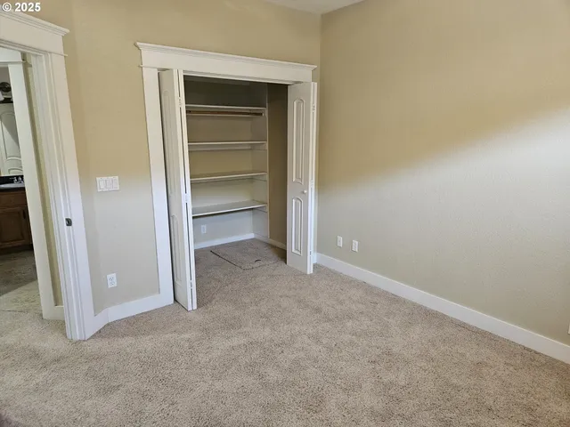 a view of an empty room with a closet