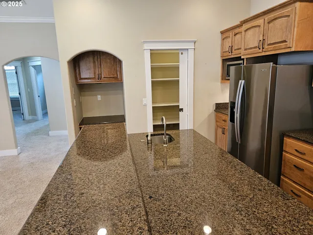 a kitchen with refrigerator and cabinets