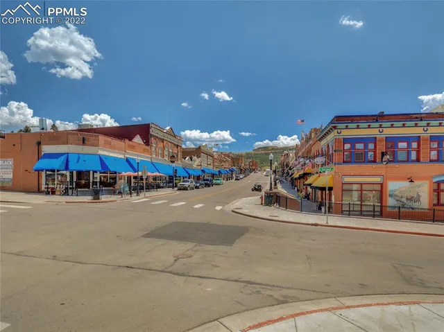 a glass building with an outdoor space and seating