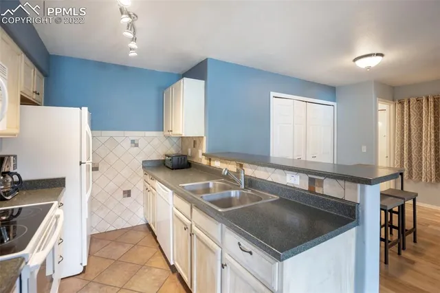 a kitchen with a sink stove and refrigerator