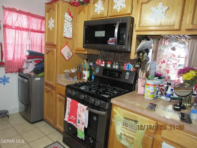 a kitchen with stainless steel appliances granite countertop a stove and a microwave