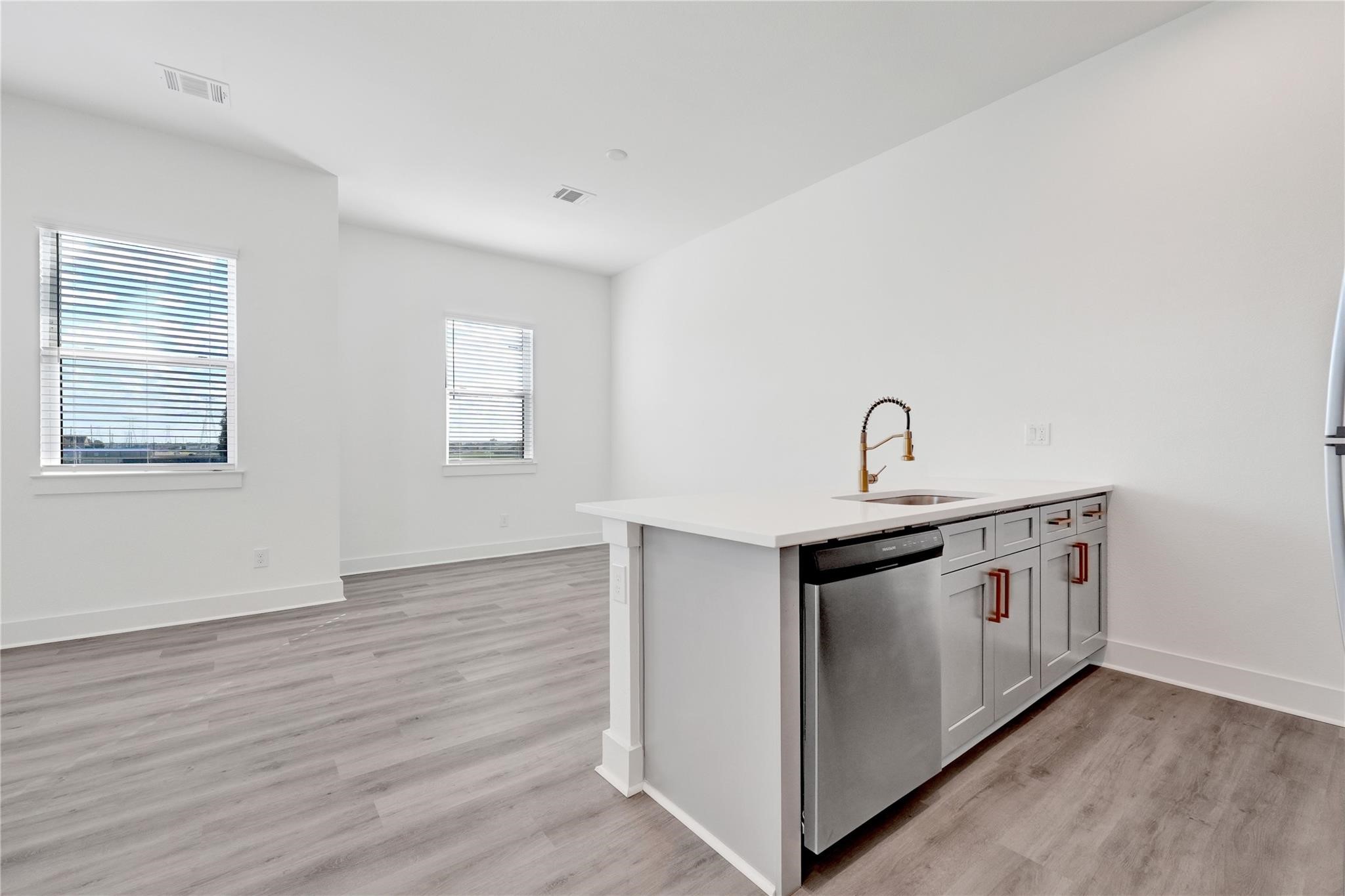 3210 Frying Pan Place, Unit B Katy, TX 77449 - Photo 14 of 49 a view of a kitchen with sink and wooden floor