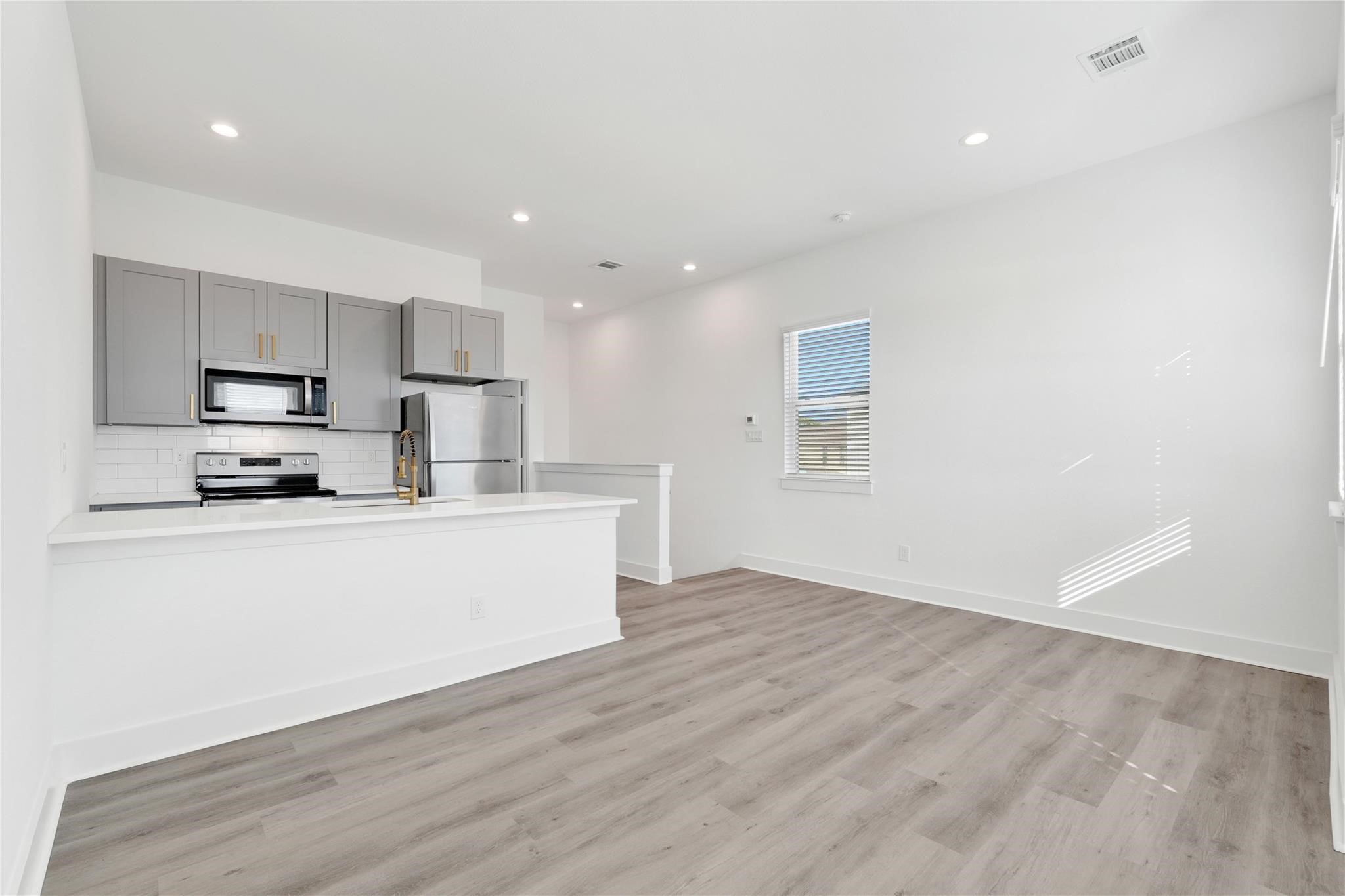 3210 Frying Pan Place, Unit B Katy, TX 77449 - Photo 20 of 49 a view of kitchen with microwave and cabinets