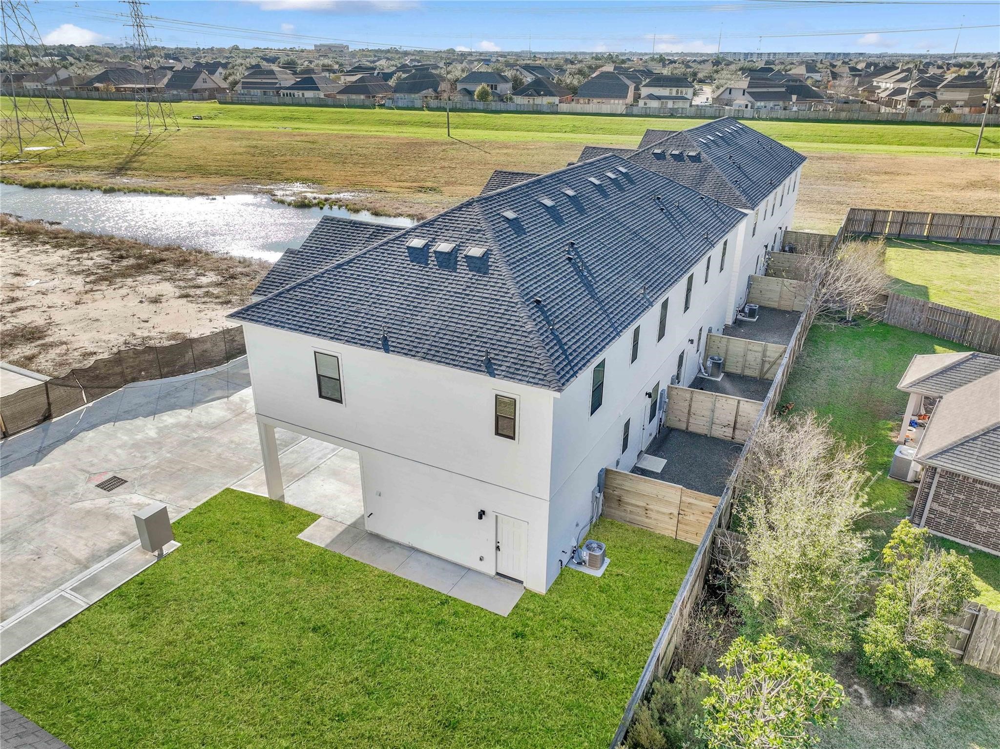 3210 Frying Pan Place, Unit B Katy, TX 77449 - Photo 45 of 49 an aerial view of a house with a garden and lake view