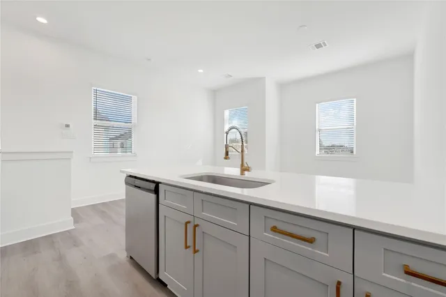 a view of kitchen with wooden floor and electronic appliances