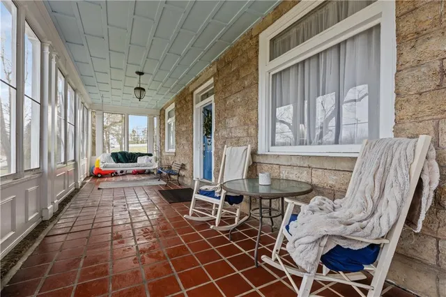 a view of a porch with a chairs and table in the patio