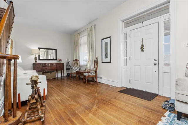 a bedroom with furniture and a wooden floor