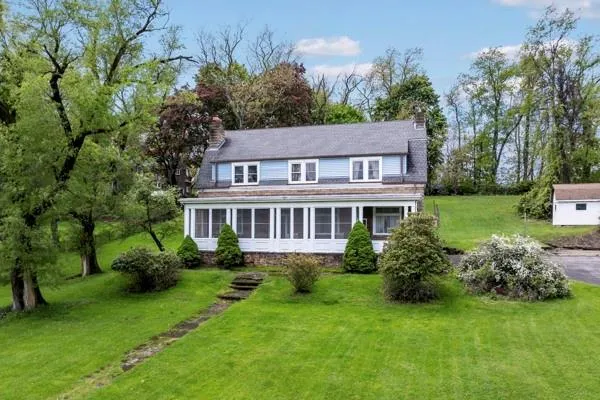 a front view of house with yard and green space