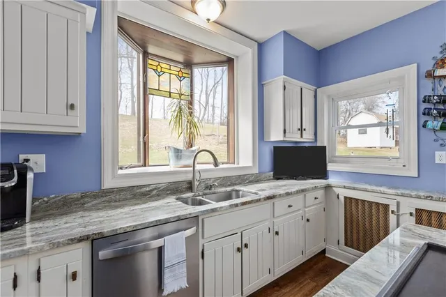 a kitchen with granite countertop a sink and a window
