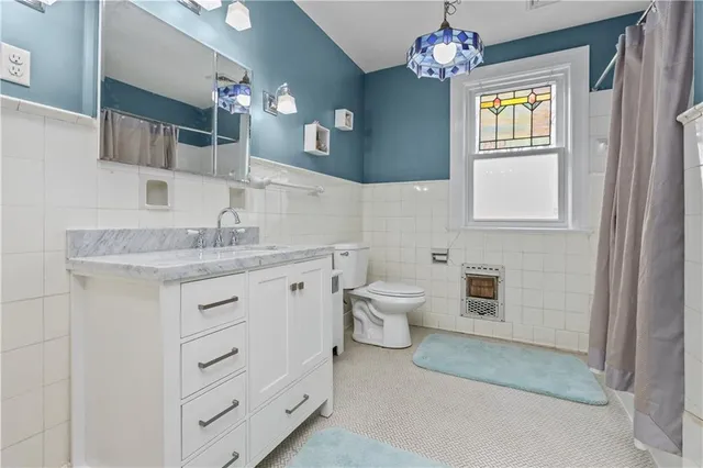 a bathroom with a sink mirror and a bathtub