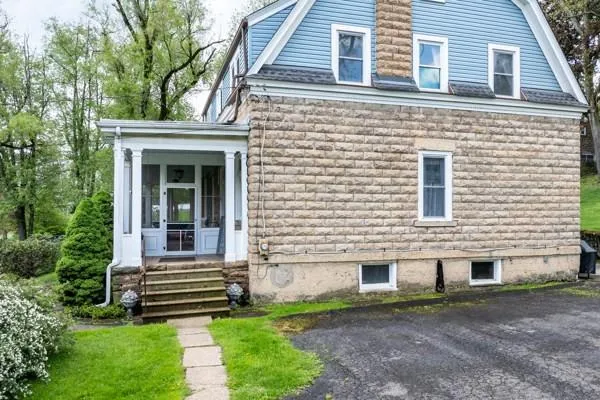a view of a house with a yard and a large window