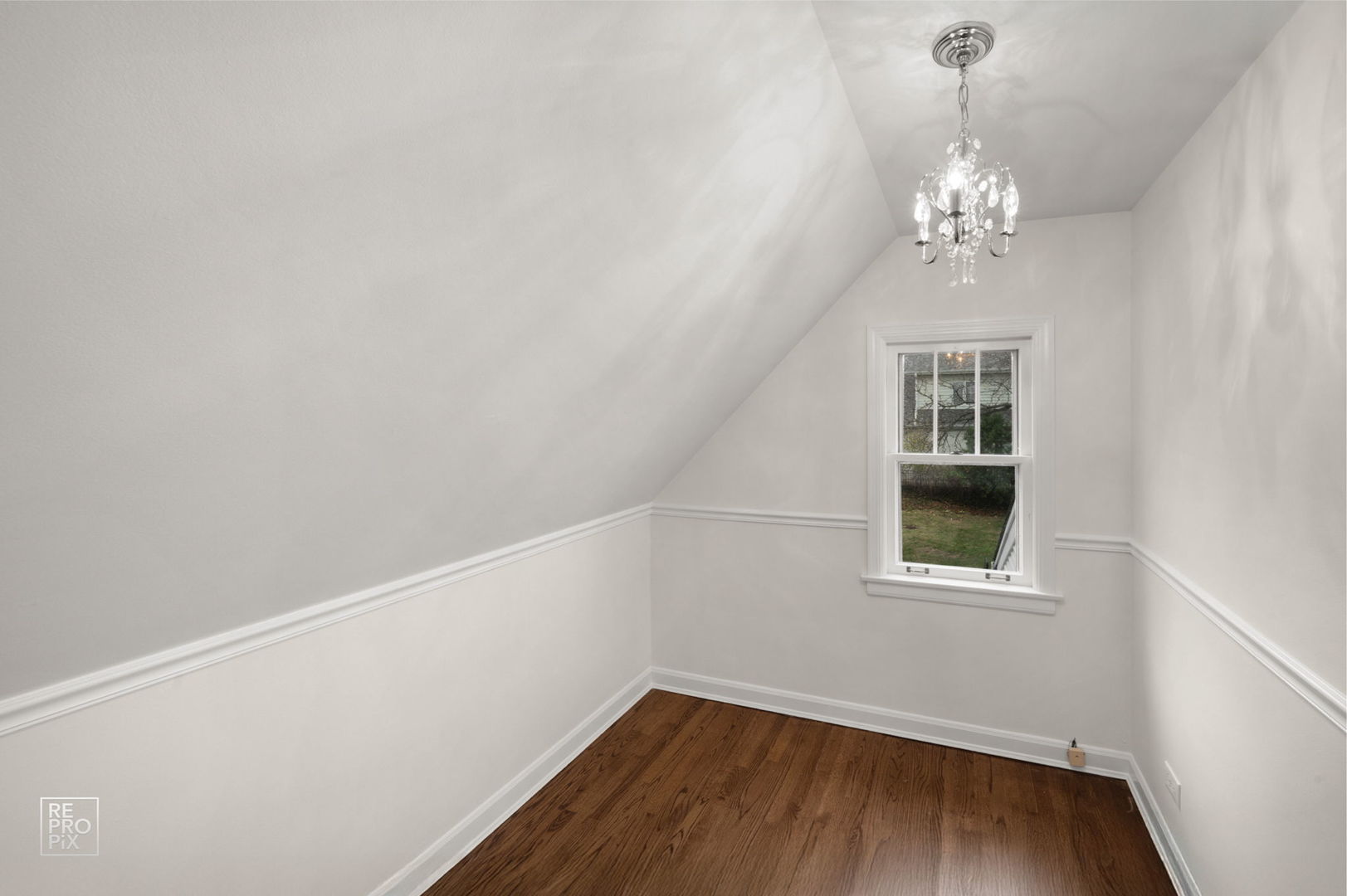 238 Grant Avenue Clarendon Hills, IL 60514 - Photo 29 of 39 a view of a room with wooden floor and chandelier