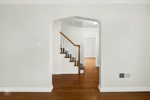 a view of entryway and hall with wooden floor