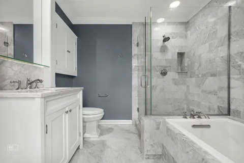 an empty room with wooden floor fireplace and windows