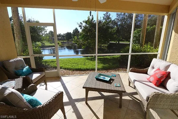 a view of a patio with couches chairs dining table and chairs barbeque grill with a small yard