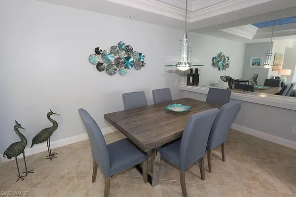 a dining room with furniture potted plants and wooden floor