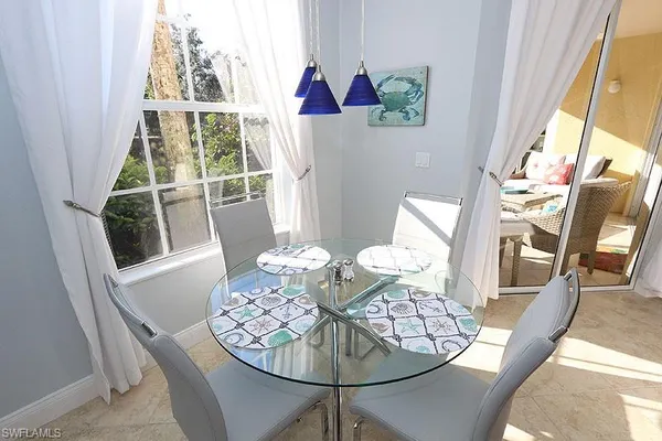a view of a dining room with furniture wooden floor and a chandelier