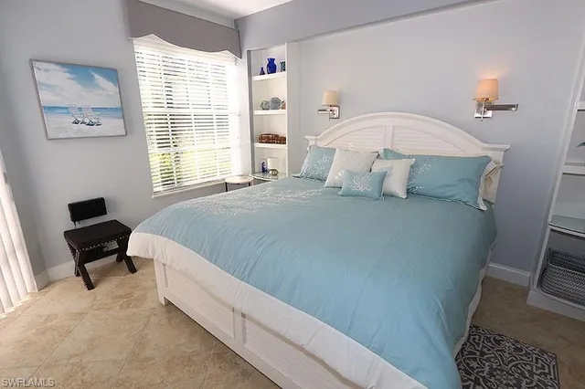 a bedroom with a bed a couch and a window