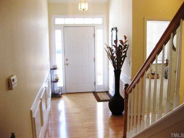 10463 Dapping Drive Raleigh, NC 27614 - Photo 2 of 12 a view of a hallway with wooden floor and staircase