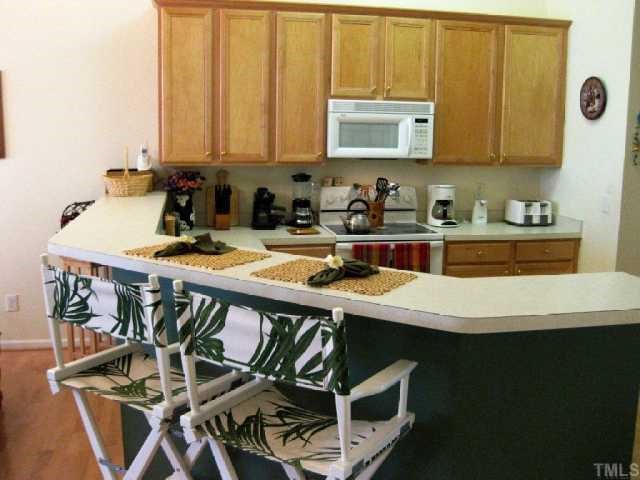 10463 Dapping Drive Raleigh, NC 27614 - Photo 4 of 12 a kitchen with a table chairs and a stove top oven