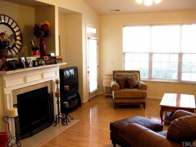 10463 Dapping Drive Raleigh, NC 27614 - Photo 6 of 12 a living room with furniture a flat screen tv and a fireplace