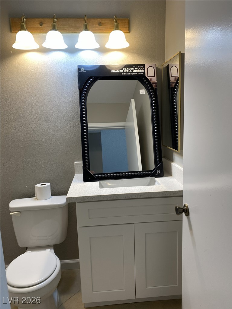 Undisclosed Address Las Vegas, NV 89108 - Photo 13 of 26 Bathroom with vanity, a textured wall, and light tile patterned floors
