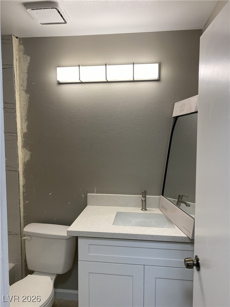 Undisclosed Address Las Vegas, NV 89108 - Photo 22 of 26 Bathroom with vanity, bathtub / shower combination, and a textured wall