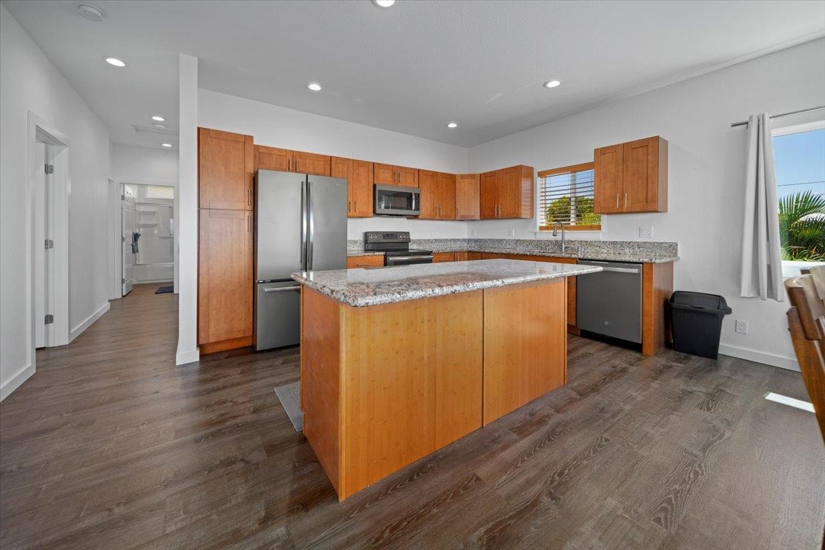 127 Wahikuli Road Lahaina, HI 96761 - Photo 13 of 27 a kitchen with stainless steel appliances granite countertop a refrigerator a sink a stove and oven