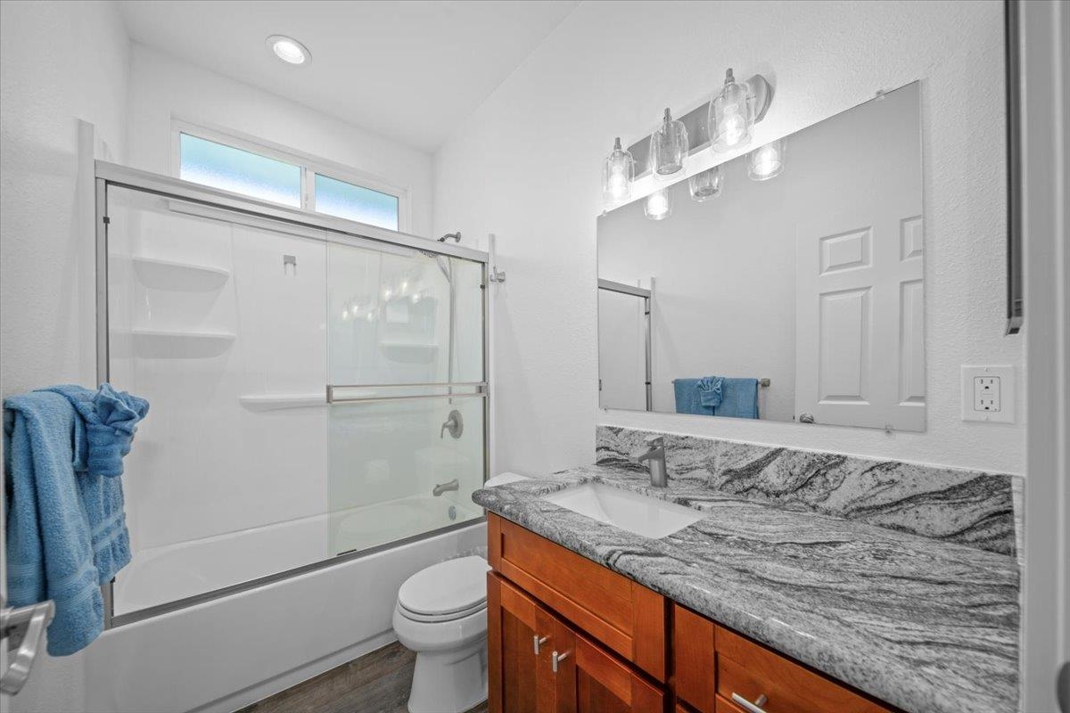 127 Wahikuli Road Lahaina, HI 96761 - Photo 16 of 27 a bathroom with a granite countertop sink a toilet and shower