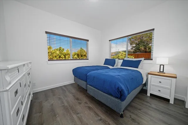 a spacious bedroom with a bed and a window