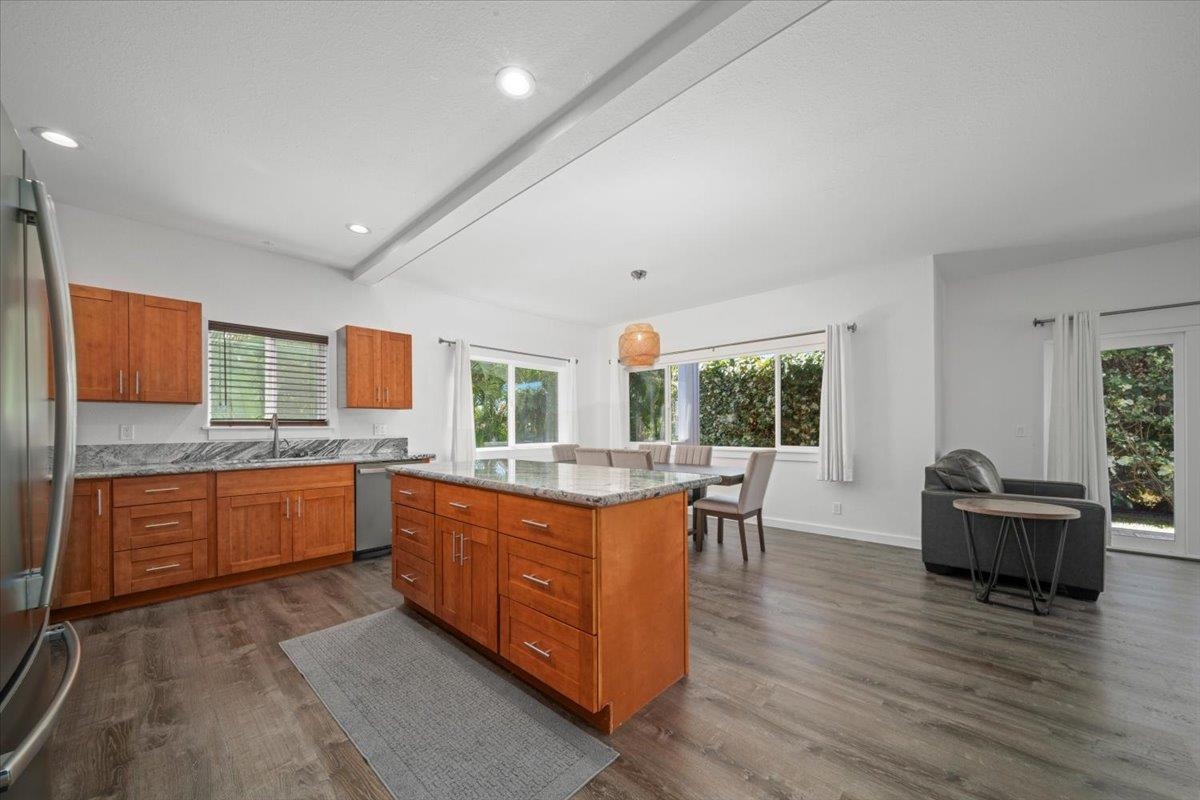 127 Wahikuli Road Lahaina, HI 96761 - Photo 21 of 27 a large kitchen with kitchen island granite countertop a sink and wooden cabinets