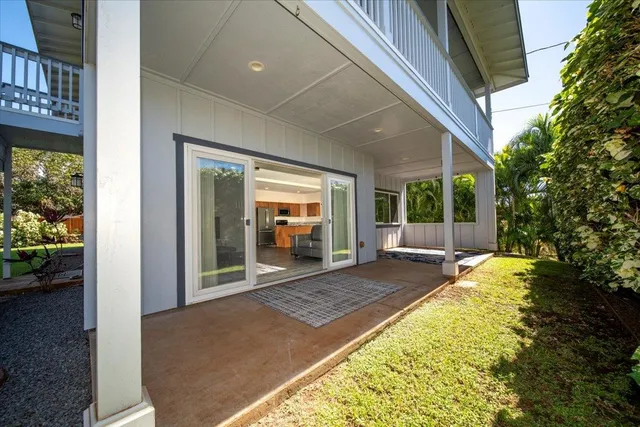 a view of a house with backyard porch and sitting area