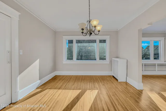 a view of a bedroom with wooden floor