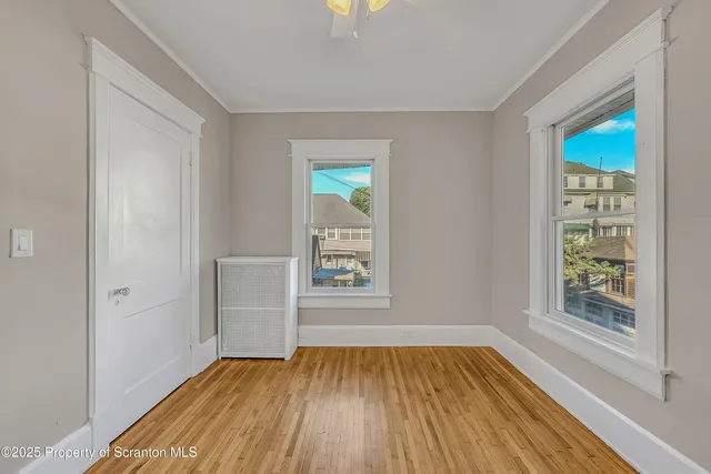 a view of a room with wooden floor and bench