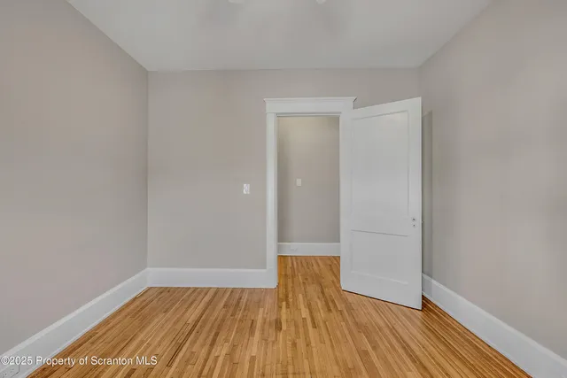 a view of a room with wooden floor