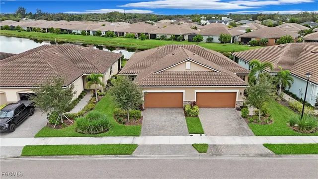 an aerial view of a house with a garden and mountain view in back