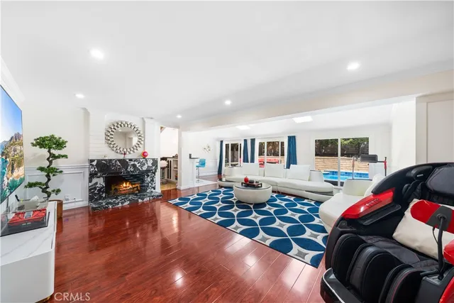 a living room with furniture fireplace and a table