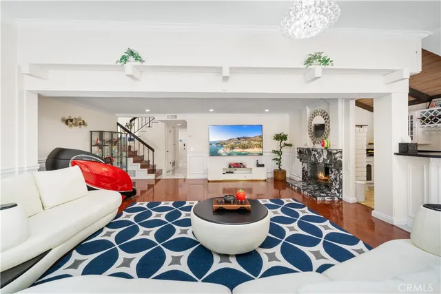 a living room with furniture and a chandelier