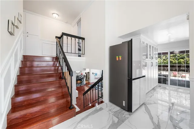 a view of entryway with stairs and wooden floor