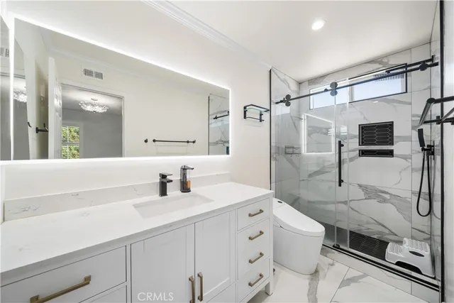 a bathroom with a double vanity sink mirror and shower