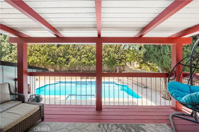 a bedroom with furniture and a large window