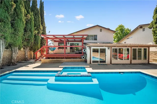 an aerial view of a house with swimming pool