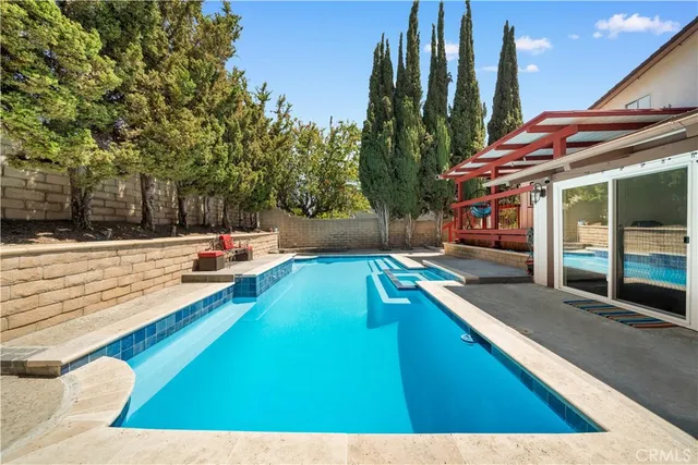 a man walking down a street next to a building