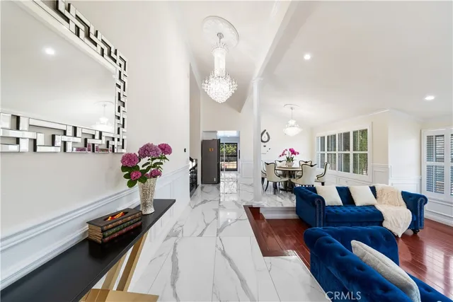 a living room with furniture fireplace and wooden floor