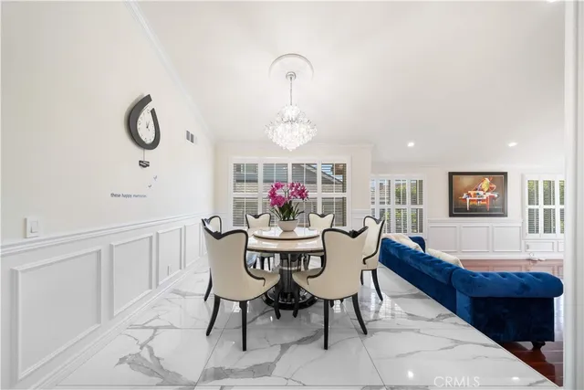 a view of a dining room with furniture wooden floor and a chandelier