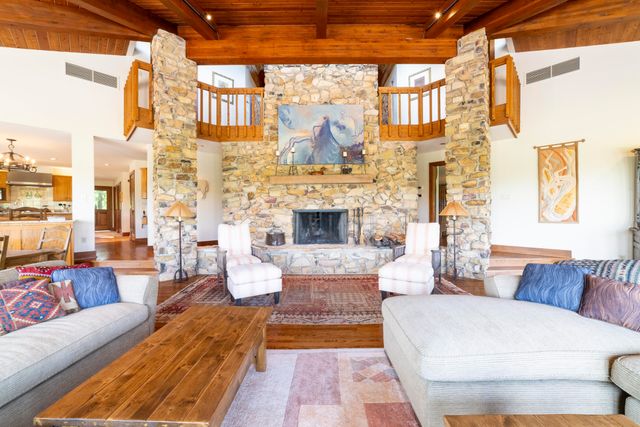 a room with furniture pool table and a large window