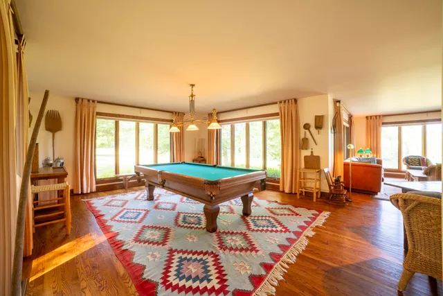 a spacious bedroom with a bed and wooden floor