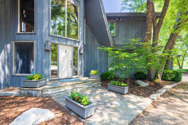 a front view of a house with a garden